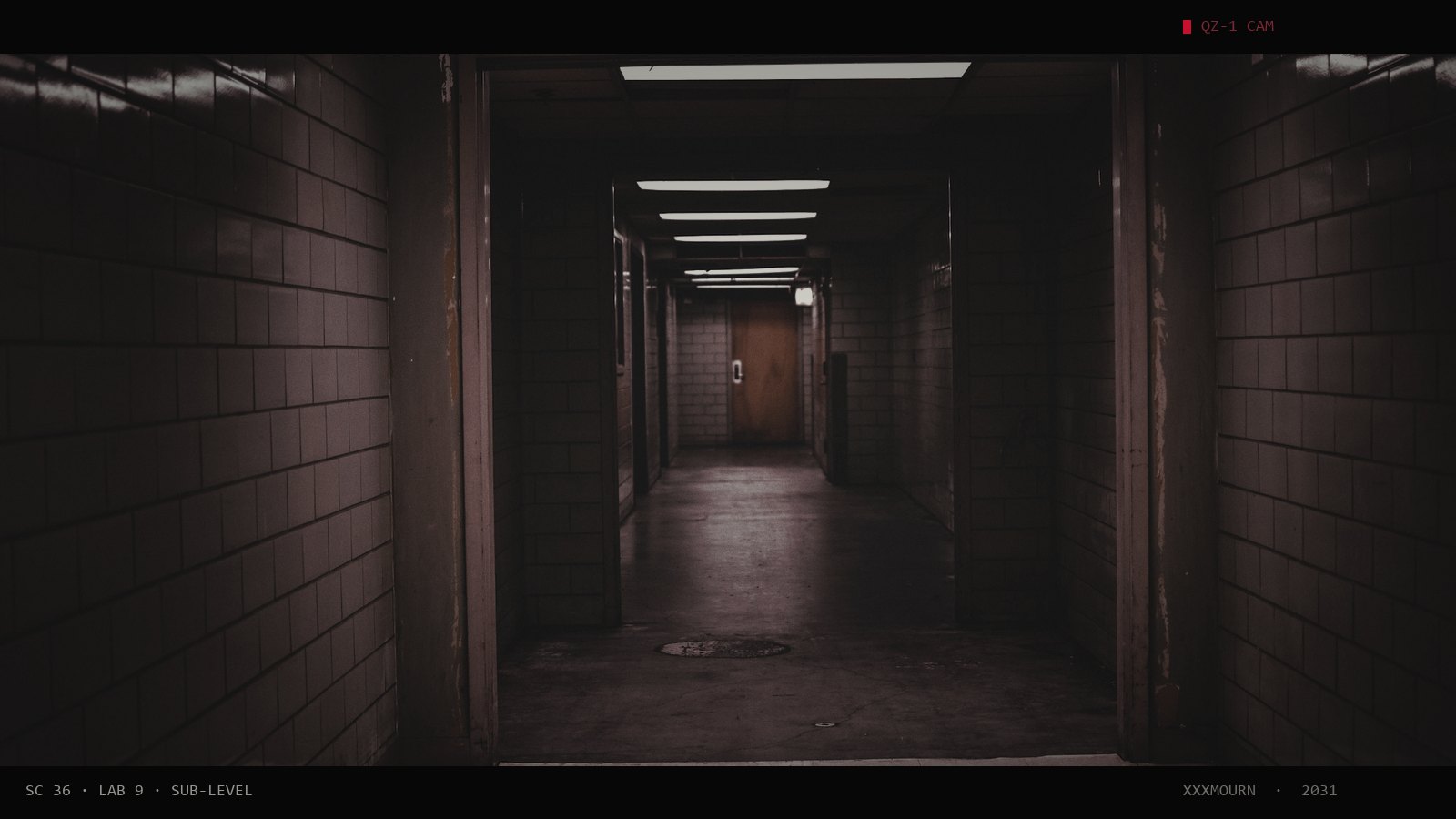 Empty tiled corridor with a lit exit sign at the far end